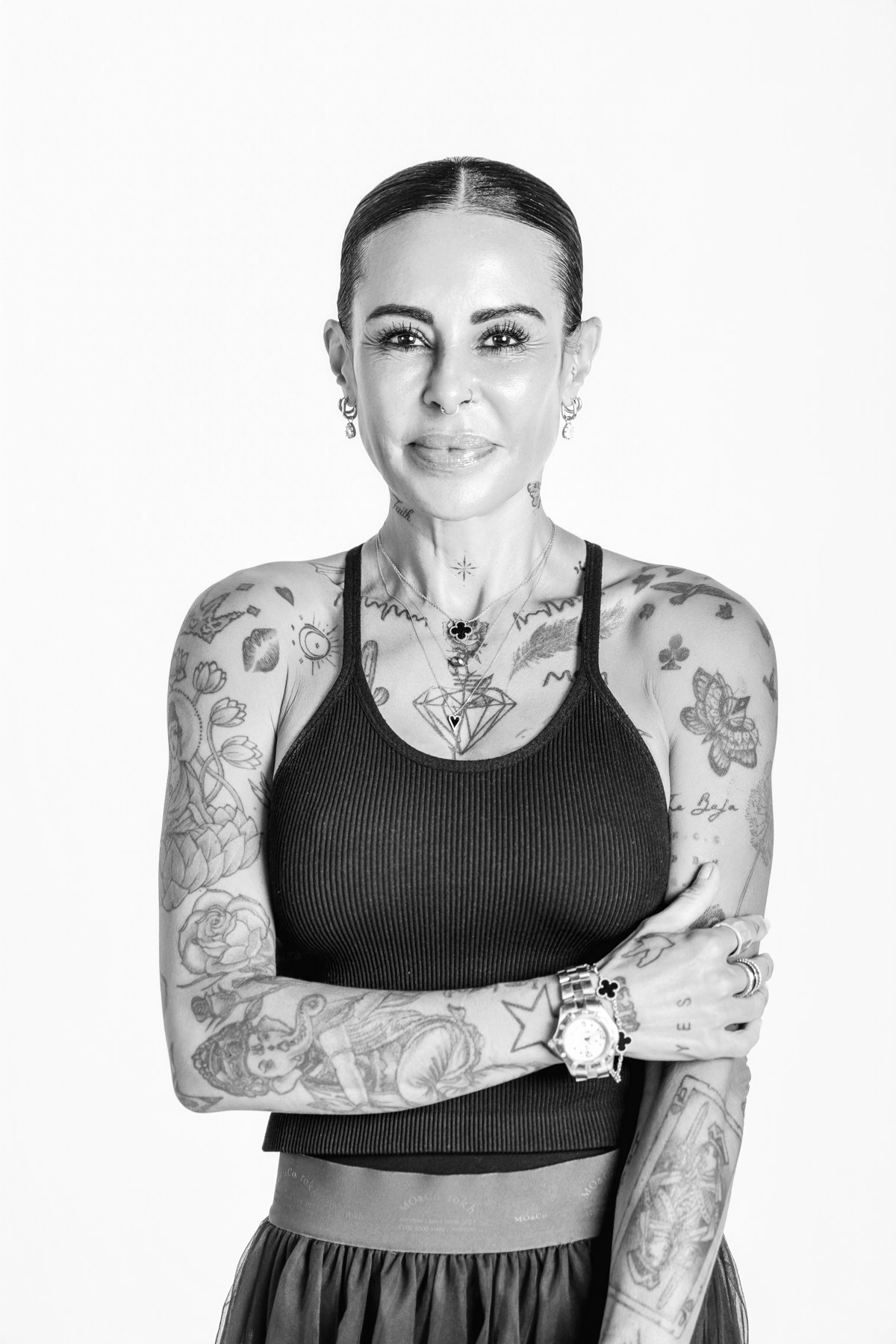Black-and-white team portrait in a sleeveless top with the same light background